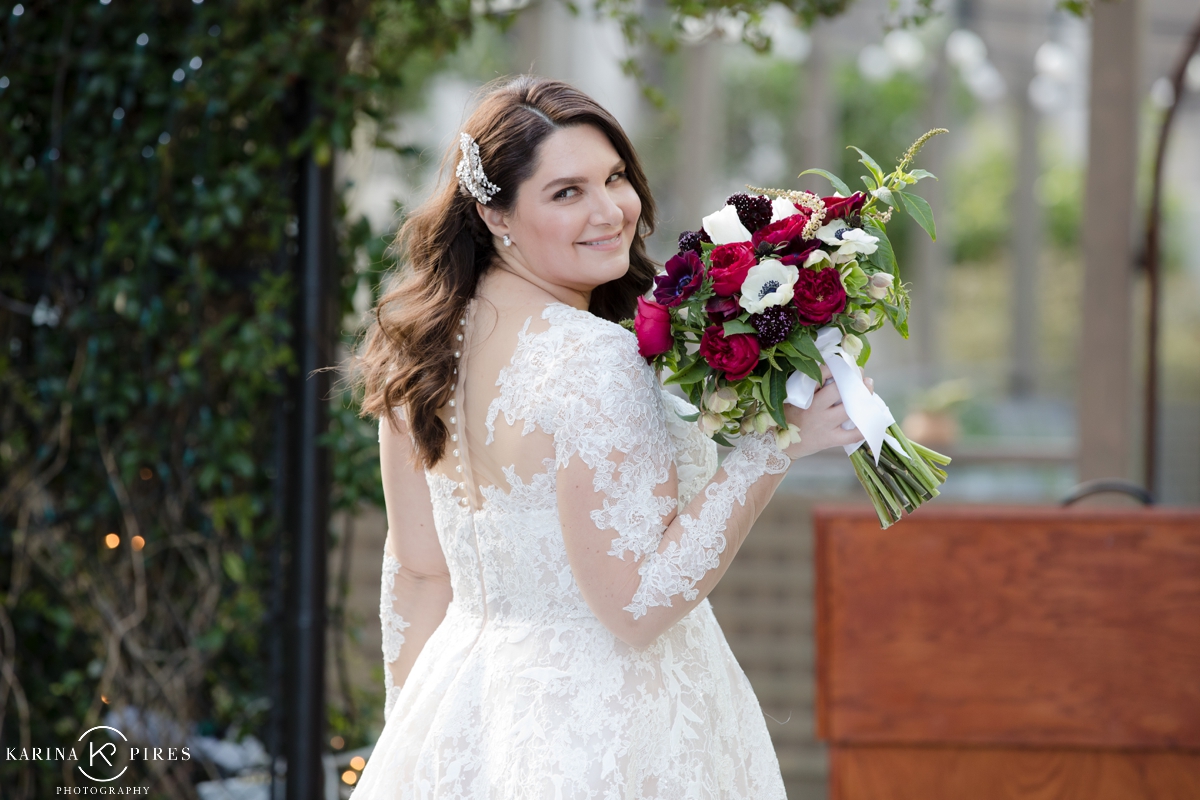 Bride holding a burgundy and white bouquet by Westwood Flower Garden