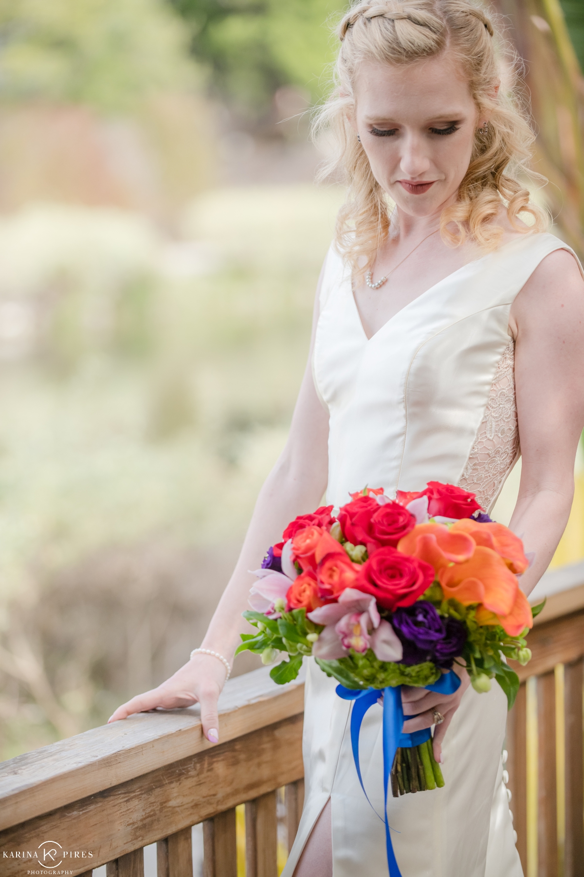Bride holding a bright bouquet with colorful flowers