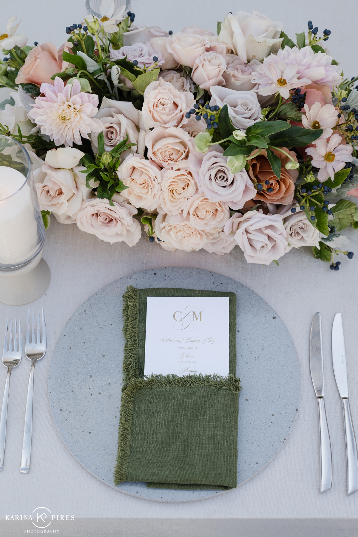 Place setting with a fringed sage green cloth napkin at a Los Angeles wedding