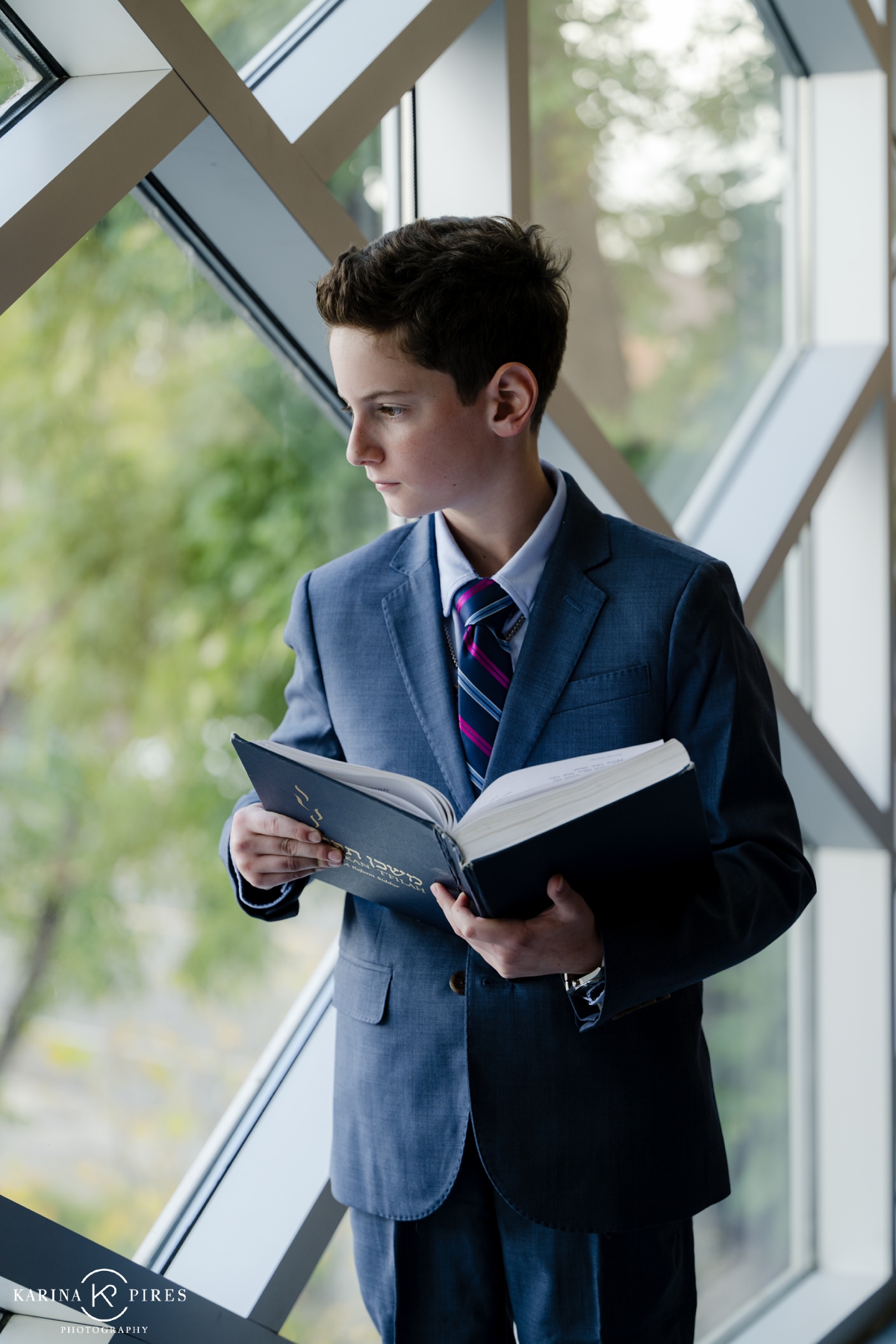 Teenage boy reading the Torah before his Bar Mitzvah service