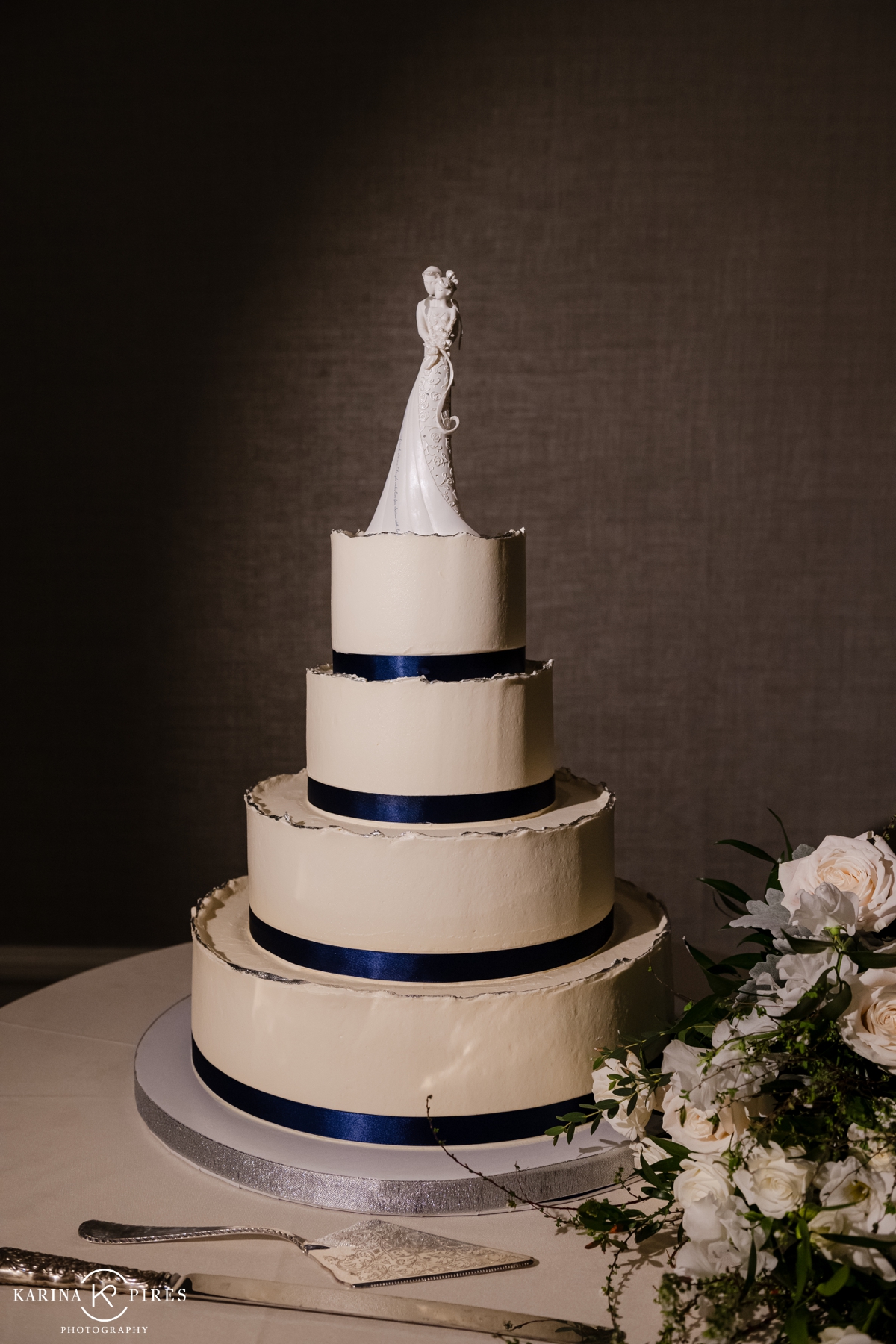 Winter wedding cake with dark blue ribbon border
