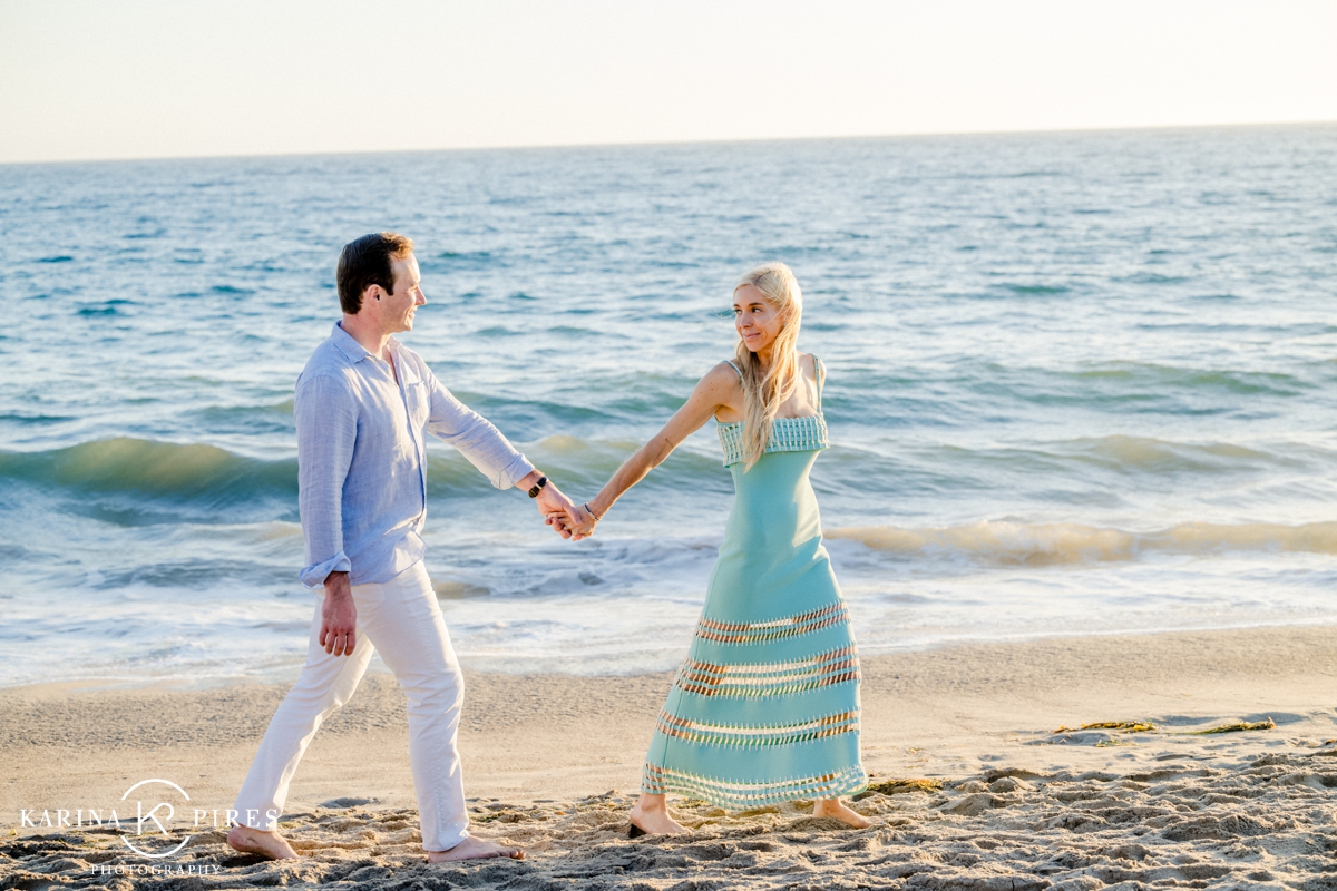 Couple walking on the beach in Malibu, California