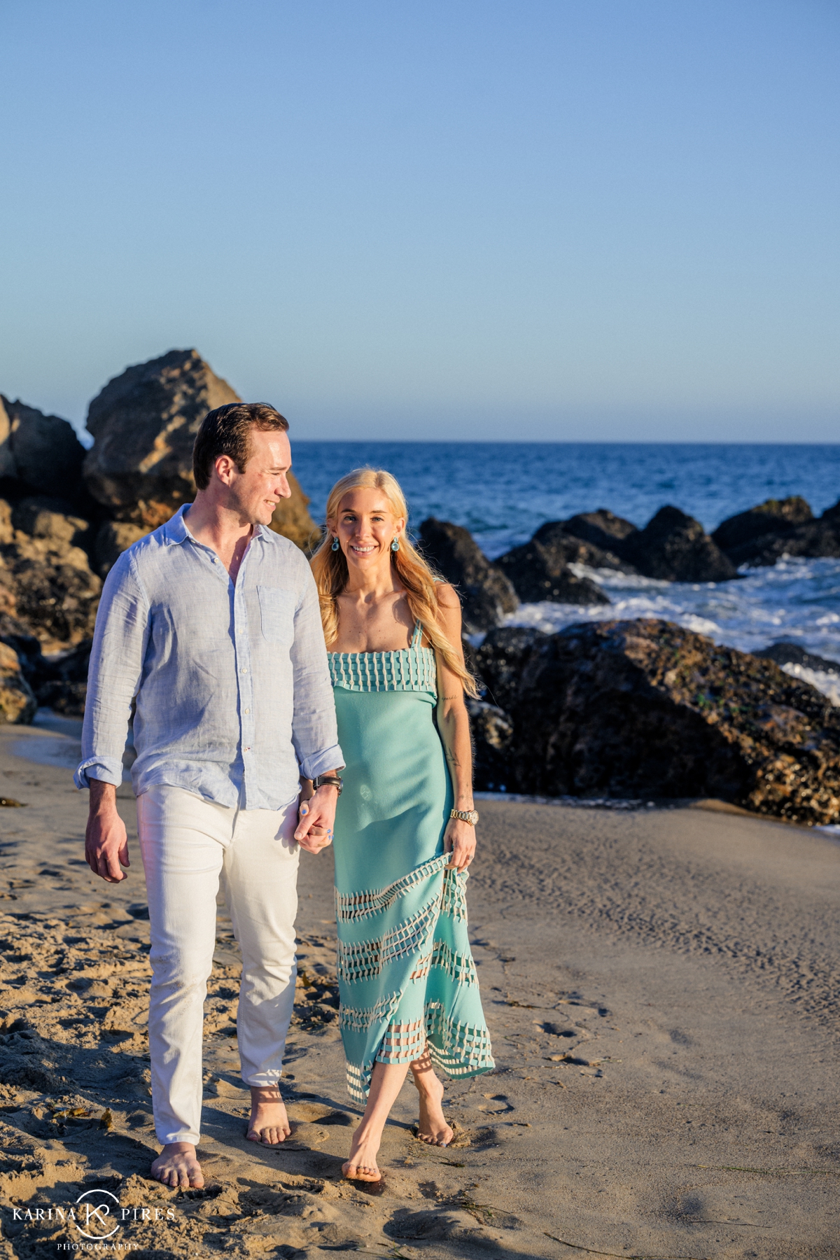 Couple walking on the beach in Malibu, California