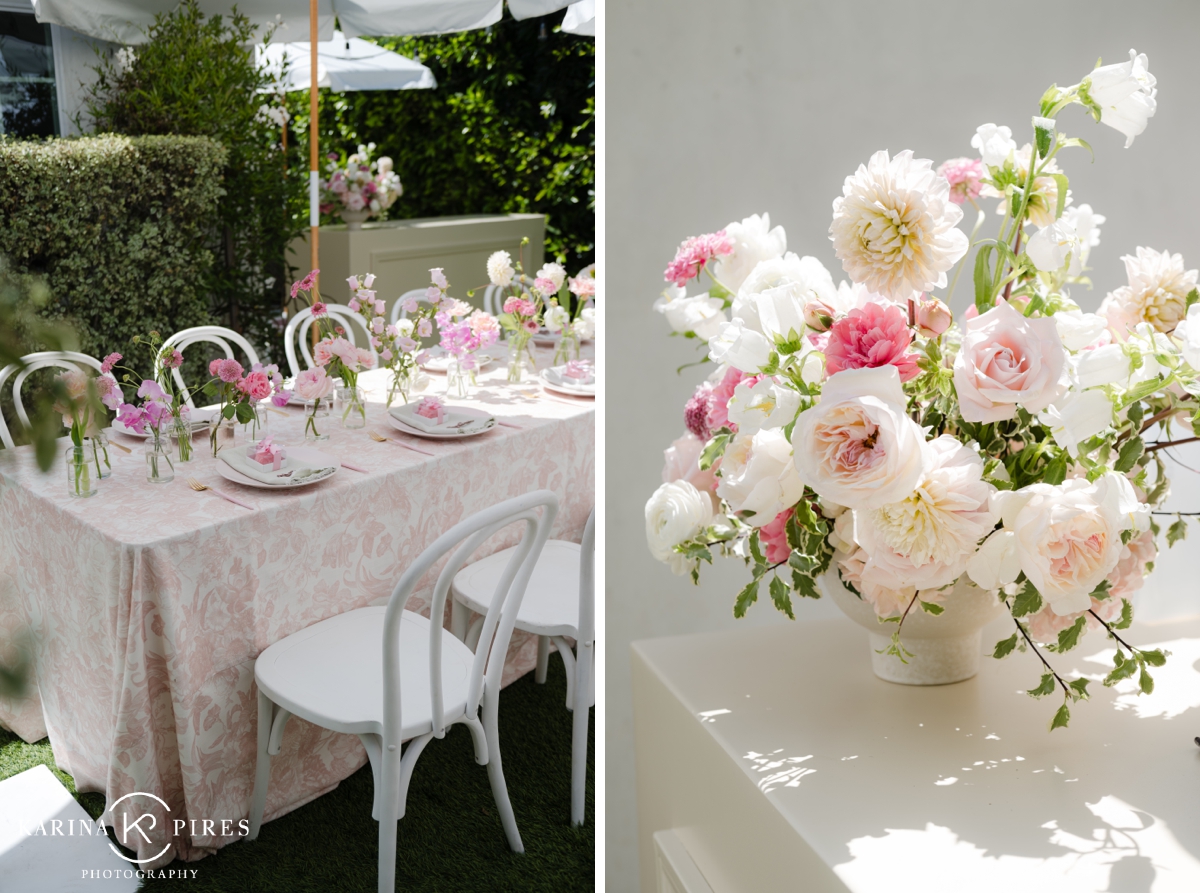 White and blush floral arrangement filled with roses, ranunculus, and dahlias inside an ivory ceramic vase