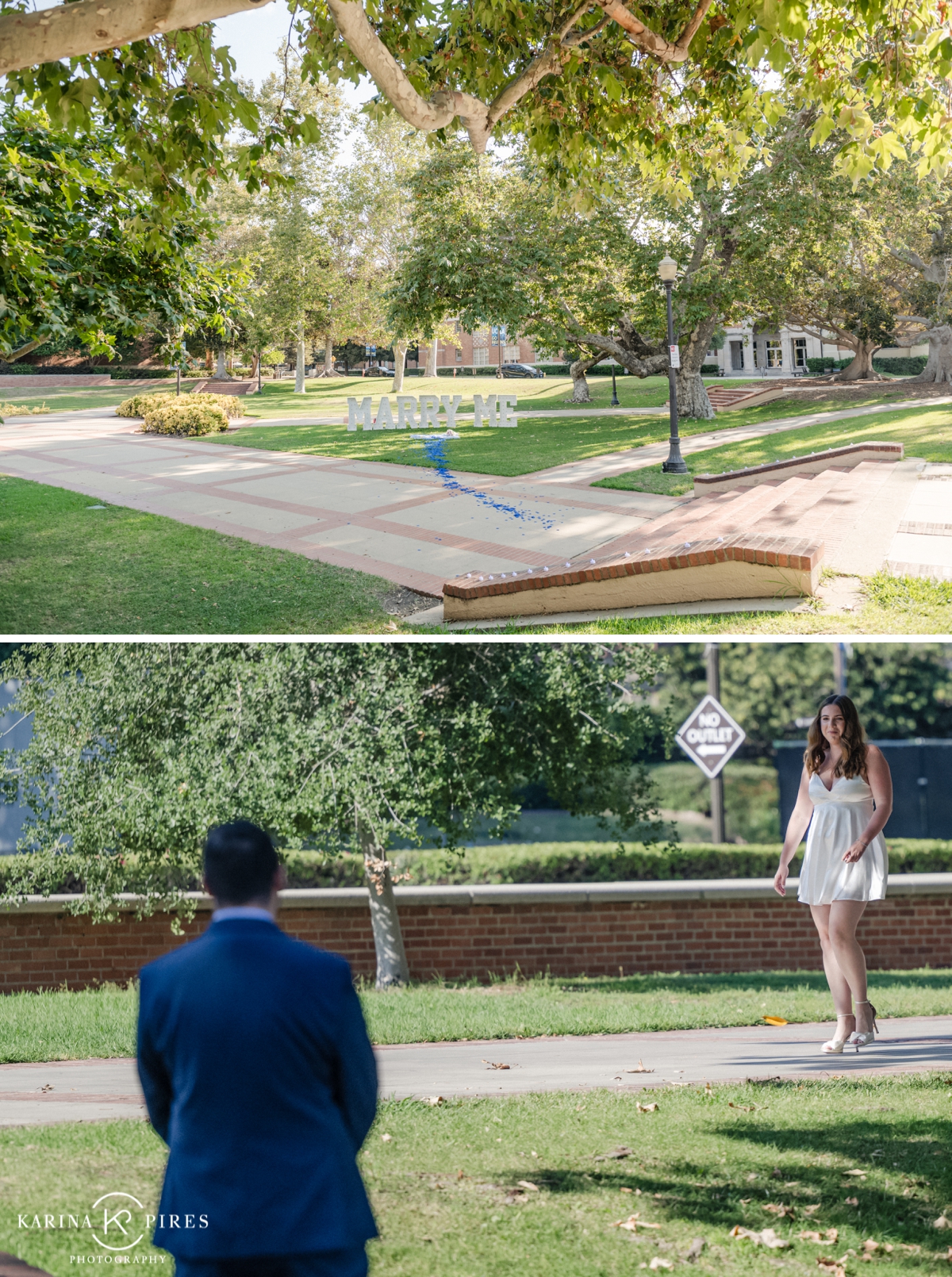 Nick on one knee proposing to Grace in front of a ‘Marry Me’ sign at UCLA during golden hour.